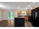 Modern kitchen with stainless steel appliances, wooden cabinets, and an island at 765 Townsville Landing Rd, Henderson, NC 27537