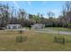 View of house and outbuildings with surrounding green space at 765 Townsville Landing Rd, Henderson, NC 27537