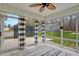 Cozy sunroom with striped curtains and plenty of natural light at 765 Townsville Landing Rd, Henderson, NC 27537