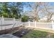 Landscaped backyard with a hammock, a hanging chair, and a white picket fence, perfect for relaxing outdoors at 801 Myrtle Grove Ln, Apex, NC 27502