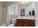 Bathroom with a shower-tub combo, vanity, and bright natural lighting, providing comfort and functionality at 801 Myrtle Grove Ln, Apex, NC 27502