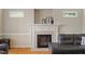 Close-up of the fireplace with a decorative mantle and light stone hearth and surround at 801 Myrtle Grove Ln, Apex, NC 27502
