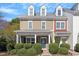 Charming townhome with dormer windows, a covered porch, and well-maintained landscaping at 801 Myrtle Grove Ln, Apex, NC 27502