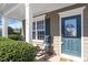 Inviting front porch with rocking chair, welcome door sign, and neatly trimmed bushes at 801 Myrtle Grove Ln, Apex, NC 27502