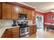 Well-lit kitchen featuring stainless steel appliances, granite countertops, and ample cabinet space at 801 Myrtle Grove Ln, Apex, NC 27502