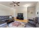 Comfortable living room with a large screen TV, ceiling fan and light, and neutral decor at 801 Myrtle Grove Ln, Apex, NC 27502