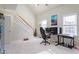 Upstairs living room featuring a gaming desk and chair with stairs leading down to the first floor at 801 Myrtle Grove Ln, Apex, NC 27502
