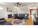Spacious living room with a leather sectional sofa, fireplace, and large decorative rug at 801 Myrtle Grove Ln, Apex, NC 27502