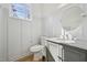 Charming half bathroom featuring custom wall trim, granite counters, and updated fixtures at 802 Pleasant Dr, Durham, NC 27703