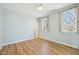 Bedroom with wood look floors, light blue walls, and a ceiling fan at 802 Pleasant Dr, Durham, NC 27703