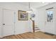 Entryway with staircase, pendant light, wood look flooring, and painting on the wall at 802 Pleasant Dr, Durham, NC 27703