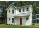 Charming two-story home with white siding, bright red door, and lush green lawn at 802 Pleasant Dr, Durham, NC 27703