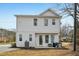 Back of home showing patio area, white siding, and rear lawn with trees at 802 Pleasant Dr, Durham, NC 27703