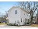 Exterior of home featuring white siding, manicured landscaping, and a rear patio at 802 Pleasant Dr, Durham, NC 27703