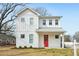 Charming two-story home featuring a bright red front door and modern white siding at 802 Pleasant Dr, Durham, NC 27703