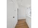 Upstairs hallway features wood look flooring, white walls, and white trim at 802 Pleasant Dr, Durham, NC 27703