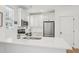 Bright kitchen features stainless appliances, white cabinetry, subway tile backsplash, and quartz countertops at 802 Pleasant Dr, Durham, NC 27703
