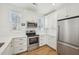 Clean and modern kitchen featuring quartz countertops, stainless steel appliances and white cabinets at 802 Pleasant Dr, Durham, NC 27703