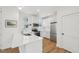 Modern kitchen with white cabinets, stainless steel appliances, and quartz countertop at 802 Pleasant Dr, Durham, NC 27703