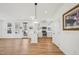 Open floor plan with white walls, wood look flooring, and view of the kitchen at 802 Pleasant Dr, Durham, NC 27703