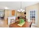 Inviting dining area with a wooden table, pendant lighting, and seamless flow into the living spaces at 829 Federal House Ave, Wake Forest, NC 27587