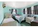 Bright bedroom with two twin beds, dresser, and neutral color palette at 902 Bragg St, Sanford, NC 27330