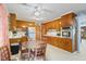 Charming kitchen with wooden cabinets, white countertops, stainless steel appliances, and a cozy dining area at 902 Bragg St, Sanford, NC 27330