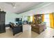 Large living room with brick fireplace, tile floor, bright windows, and neutral color palette throughout at 902 Bragg St, Sanford, NC 27330