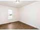 Bright, airy bedroom featuring a large window and stylish, contemporary flooring at 936 Amersham Ln, Wake Forest, NC 27587