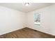 Bright, airy bedroom featuring a large window and stylish, contemporary flooring at 936 Amersham Ln, Wake Forest, NC 27587