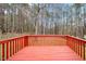 View of the red painted deck overlooking backyard and trees at 936 Amersham Ln, Wake Forest, NC 27587