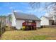 Rear exterior view of home with red painted deck at 936 Amersham Ln, Wake Forest, NC 27587