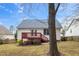 Rear exterior view of home with red painted deck at 936 Amersham Ln, Wake Forest, NC 27587