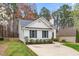Well-maintained single-story home featuring a spacious driveway and landscaped surroundings at 936 Amersham Ln, Wake Forest, NC 27587