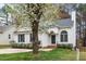 Charming single-story home featuring a blossoming tree, landscaped yard, and inviting entrance at 936 Amersham Ln, Wake Forest, NC 27587