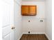 Functional laundry room with built-in cabinets and utility connections at 936 Amersham Ln, Wake Forest, NC 27587
