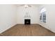 Open-concept living room features hardwood floors, a fireplace, and an abundance of natural light at 936 Amersham Ln, Wake Forest, NC 27587