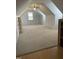 Attic space with carpet, skylights, and ceiling fan at 100 Blackberry Creek Dr, Willow Springs, NC 27592