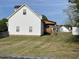 Spacious backyard view featuring a quaint deck and partial privacy fence at 100 Blackberry Creek Dr, Willow Springs, NC 27592