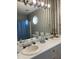 Bathroom with a double vanity, wallpaper, and decorative mirror at 100 Blackberry Creek Dr, Willow Springs, NC 27592