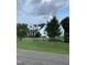 Beautiful two-story home with lush landscaping, a chimney, and a large front yard at 100 Blackberry Creek Dr, Willow Springs, NC 27592