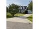 Traditional two-story home with a long driveway, manicured lawn, and mature trees at 100 Blackberry Creek Dr, Willow Springs, NC 27592