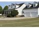 Charming two-story home showcasing a three-car garage and well-manicured lawn at 100 Blackberry Creek Dr, Willow Springs, NC 27592