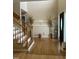 Welcoming foyer with hardwood floors, staircase, and elegant decor at 100 Blackberry Creek Dr, Willow Springs, NC 27592