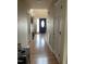 Hallway view with hardwood floors, leading to a black front door at 100 Blackberry Creek Dr, Willow Springs, NC 27592