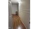 Hallway with wood-look floors and two doors at 100 Blackberry Creek Dr, Willow Springs, NC 27592