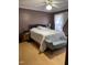 Cozy main bedroom features neutral walls, wood-look floors, ceiling fan and large window at 100 Blackberry Creek Dr, Willow Springs, NC 27592