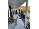 Inviting front porch with classic columns and decorative seating, offering a serene view at 100 Blackberry Creek Dr, Willow Springs, NC 27592