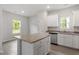 Stylish kitchen island with granite countertop, adjacent to stainless steel appliances and cabinetry at 101 Shelfit Trl, Oxford, NC 27565