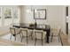 Elegant dining room with a marble table, upholstered chairs, and lots of natural light at 108 N Stonemill Trl # Homesite 254, Wilson's Mills, NC 27520